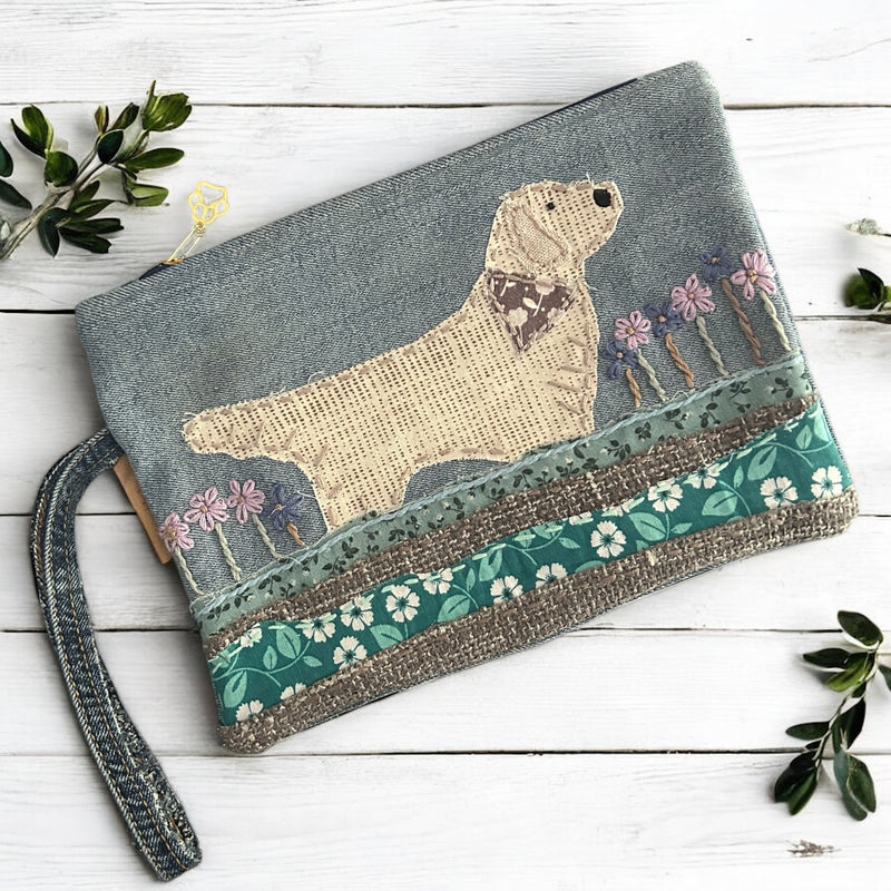 The Pupperfish Golden retriever playing in the garden, hand embroidered on upcycled denim.