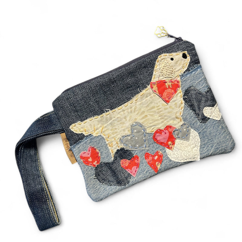 The Pupperfish Handmade golden retriever zipper pouch with hand embroidered golden retriever in hearts. Materials are a mix of vintage fabrics and upcycled denim.