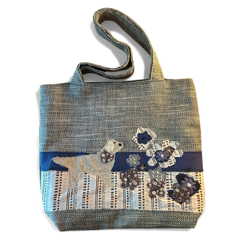 The Pupperfish Hand stitched golden retriever smelling flowers on handmade tweed tote bag.