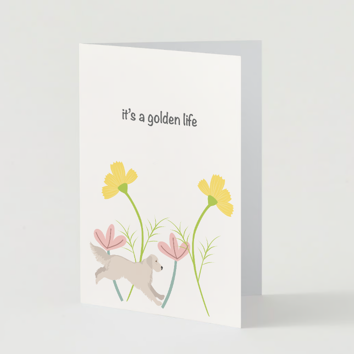 The Pupperfish "It's a golden life" golden retriever birthday card featuring a golden retriever jumping through flowers